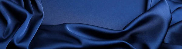 Blue fabric with folds on a dark blue background